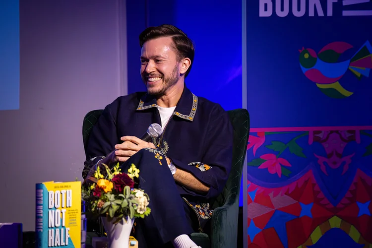 Jassa laughing on stage at Wimbledon BookFest